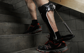 man climbing stairs with a passive-elastic ankle exoskeleton attached