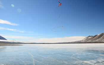 A helicopter flies the AEM sensor over Lake Frxyell in the McMurdo Dry Valleys.