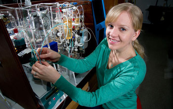 oceanographer Katie Shamberger with instruments that measure carbon dioxide in seawater.
