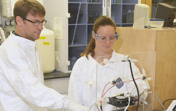 Scientists Carl Lamborg (left) and Gretchen Swarr of WHOI working in the lab