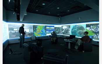 Weather data and visualizations surround researchers using the Social Computing Room at UNC.
