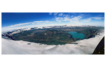 Caldera of the Okmok volcano with Vsevidof and Recheshnoi volcanoes in the distance