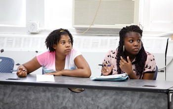 Two young women at a desk