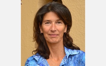 Woman in a blue shirt and shoulder-length hair