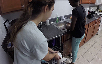 Two women washing dishes