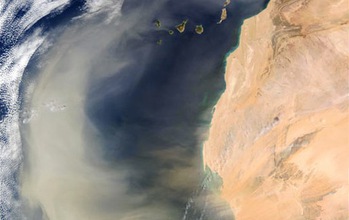 A massive dust plume over the Atlantic Ocean, caused by a dust storm in the Sahara Desert.