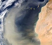 A massive dust plume over the Atlantic Ocean, caused by a dust storm in the Sahara Desert.
