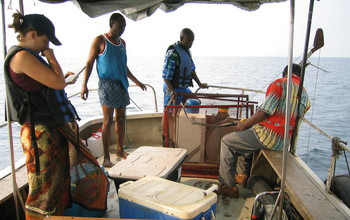 Four researchers on a boat on Lake Tanganyika