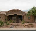 Photo of a house  with  xeriscaping featuriing a stone garden and palm trees