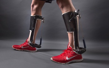 men's legs with a passive-elastic ankle exoskeleton attached