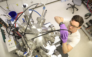 A graduate student performs experiments on the formation of hafnium oxide