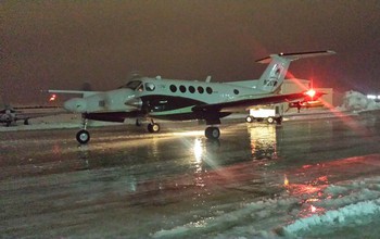 The NSF-supported University of Wyoming King Air research plane taxis across an icy tarmac.