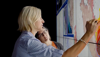 two women working on a board