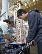 High School Acceleration Academy students fasten a balsa wood tower they have built to a shake table