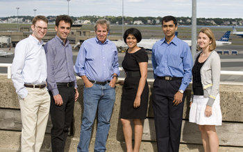 team of 6 MIT scientists standing at the airport
