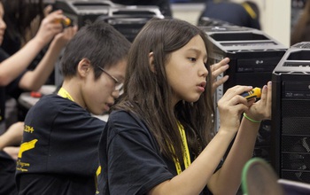 Middle School Academy students building computers.