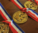 Three National Medals of Science laid out on a table