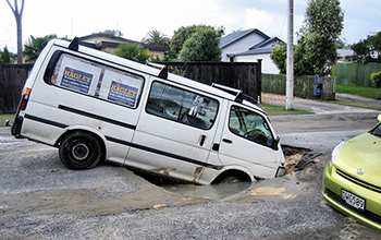 Sink holes and liquefaction on roads in Christchurch, New Zealand.