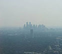 Photo of Houston's downtown skyline obscured by air pollution.