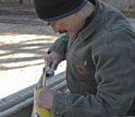 Photo of marine scientist Craig Lee finishing assembly of an underwater glider.