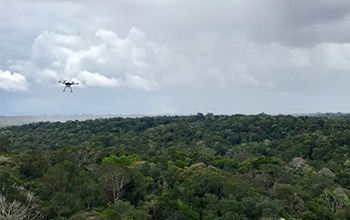 a drone flies toward a rainstorm in the Amazon