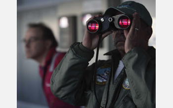 Photo of ice observer Diego Mello and first mate Steve Bradley on the lookout for icebergs.