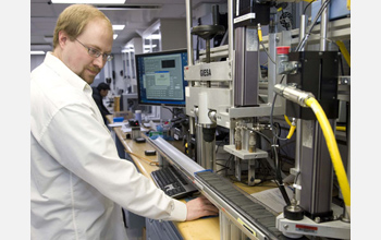 Photo of Travis Hayden taking measurements from a core section.