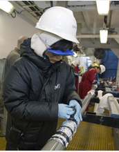 Photo of Saiko Sugisaki preparing a core for sampling.