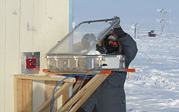 Scientist conductiong a snow-chamber experiment