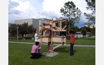 Students participating in David Snider's class measure the dimensions of a work of modern art.