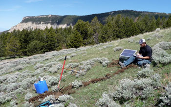 Photo of Jeremiah Silver downloading EarthScope data from a seismic station.