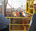 Photo of co-chief scientists Donna Blackman and Alistair Harding looking across the rig floor.