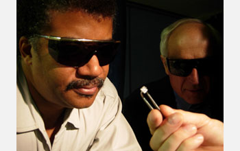 Photo of Neil deGrasse Tyson examining an unpolished man-made diamond, fresh out of the grower.