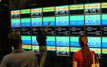 Photo of UC Irvine's HIperWall system measuring 23 x 9 feet with 50 flat-panel tiles.