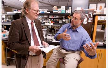 Photo of Jonathan Arnold and Heinz-Bernd Schuttler discussing their work on biological clocks.