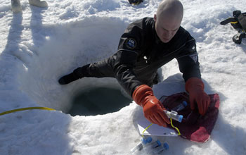 Preparing sample bottles for dive into frigid waters of McMurdo Sound, Antarctica