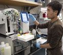 Photo of a researcher conducting a geochemical analysis of the water in ocean-floor sediments.