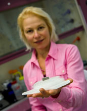 Photo of Caltech materials science expert Julia Greer holding micro-lattice ultralight metal.