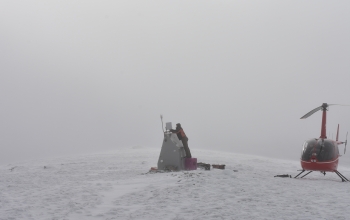 Field operations manager Ryan Bierma makes last adjustments to station C19K as a blizzard rolls in.