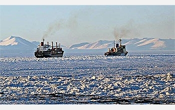 The icebreaker Krasin escorts the cargo ship American Tern out of McMurdo Sound.