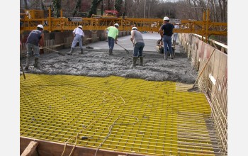 Workers covered the composites with concrete in the final steps of the bridge renovation