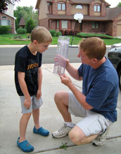 Photo of a father and son measuring rainfall data in Concord, N.C.