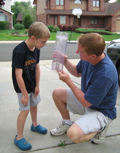 father and son with rain gauge