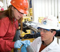 Microbiologist Maria-Cristina Ciobanu and geochemist Simon George sample a core.