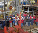 Expedition 317 participants celebrate the recovery of a core from the deepest hole drilled.