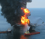 A photo of the Deepwater Horizon oil drilling rig on fire at the time of the spill.
