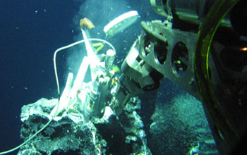 a robotic device measuring chemosynthetic processes at a hydrothermal vent in deep ocean.