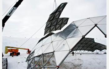 Photo of a crane removing a section of the geodesic dome at Amundsen-Scott South Pole Station.