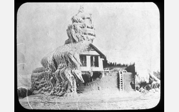 a snowdrift on the side of a house.