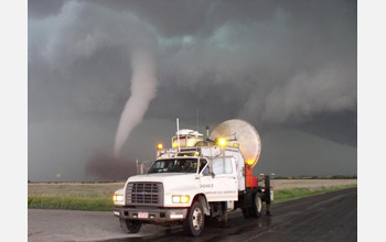 Photo of a tornado on the horizon and the DOW in the foreground.